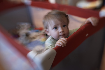 Image showing cute little baby playing in mobile bed