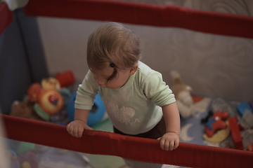 Image showing cute little baby playing in mobile bed