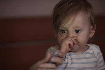 Image showing cute little baby playing and making first steps