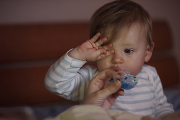 Image showing cute little baby playing and making first steps