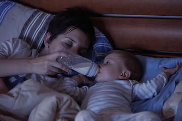 Image showing baby eating milk from bottle