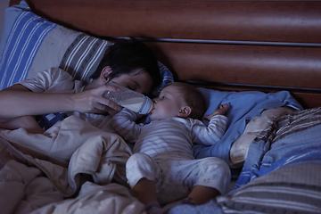 Image showing baby eating milk from bottle