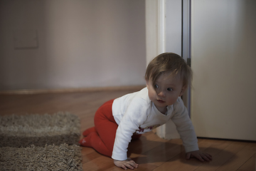 Image showing cute little one year old baby and making first steps