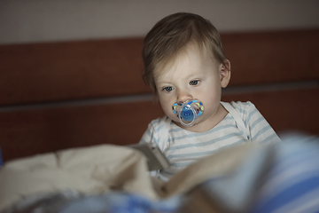 Image showing cute little baby playing and making first steps