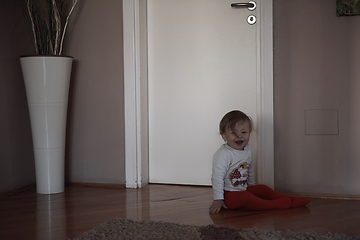 Image showing cute little one year old baby and making first steps