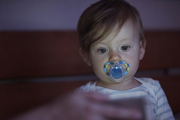 Image showing cute little baby playing and making first steps