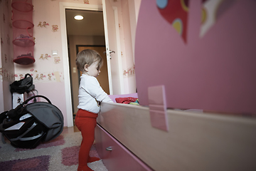 Image showing cute little one year old baby and making first steps