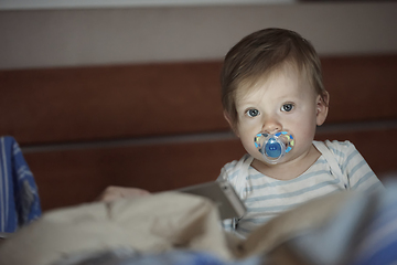 Image showing cute little baby playing and making first steps