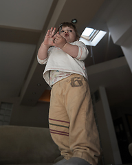 Image showing Adorable cute beautiful little baby girl playing with toys at home