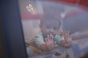 Image showing cute little baby playing in mobile bed