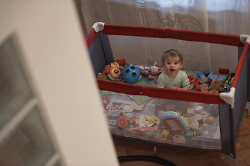 Image showing cute little baby playing in mobile bed