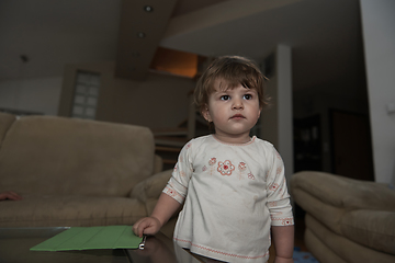 Image showing Adorable cute beautiful little baby girl playing with toys at home