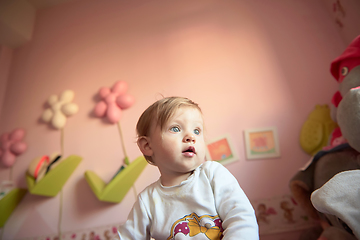 Image showing cute little one year old baby and making first steps