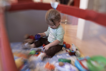 Image showing cute little baby playing in mobile bed