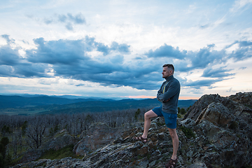 Image showing Man standing on top of cliff