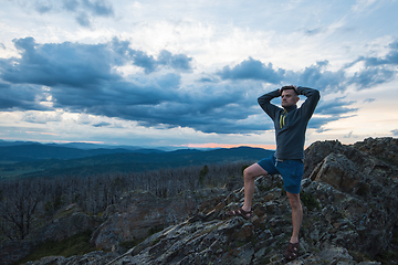 Image showing Man standing on top of cliff