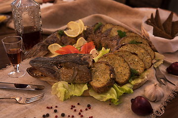 Image showing Stuffed pike with vegetables and greens.