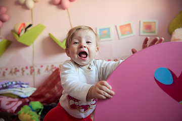 Image showing cute little one year old baby and making first steps