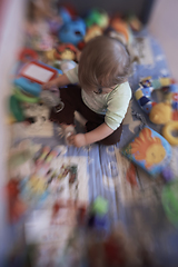 Image showing cute little baby playing in mobile bed