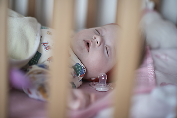 Image showing newborn baby sleeping at home in bed