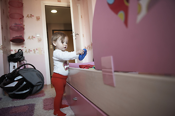 Image showing cute little one year old baby and making first steps