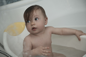 Image showing cute little baby girl taking a bath