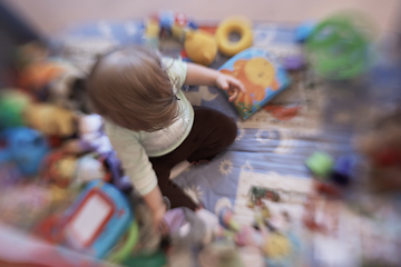 Image showing cute little baby playing in mobile bed