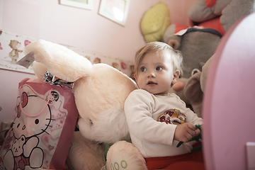 Image showing cute little one year old baby and making first steps