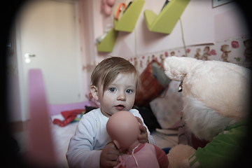 Image showing cute little one year old baby and making first steps