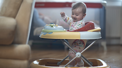 Image showing baby learning to walk in walker