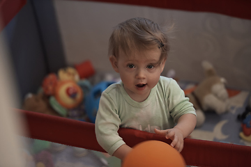 Image showing cute little baby playing in mobile bed