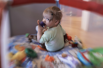 Image showing cute little baby playing in mobile bed