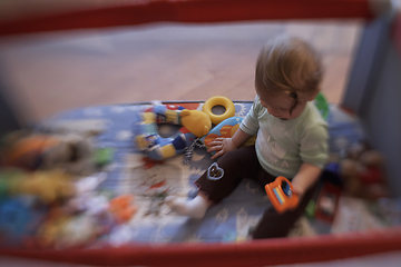 Image showing cute little baby playing in mobile bed