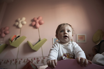 Image showing cute little one year old baby and making first steps