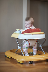 Image showing baby learning to walk in walker