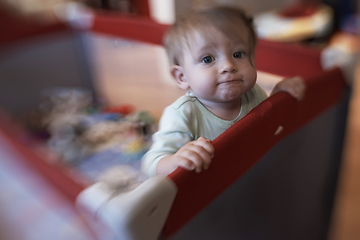 Image showing cute little baby playing in mobile bed