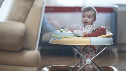 Image showing baby learning to walk in walker