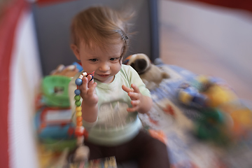 Image showing cute little baby playing in mobile bed