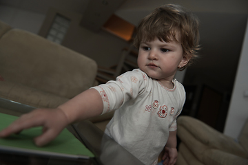 Image showing Adorable cute beautiful little baby girl playing with toys at home