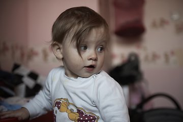 Image showing cute little one year old baby and making first steps