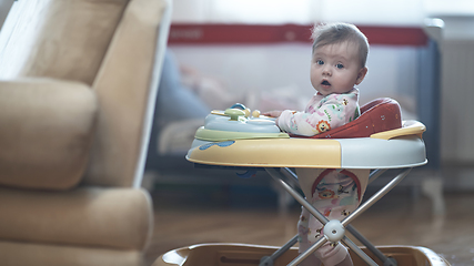 Image showing baby learning to walk in walker