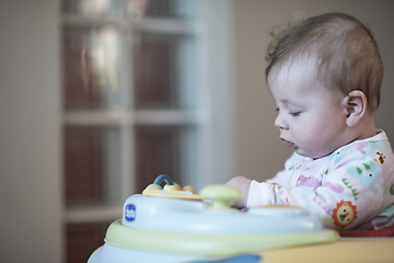 Image showing baby learning to walk in walker