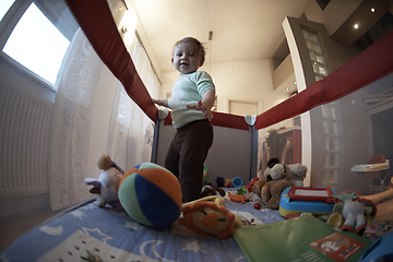 Image showing cute little baby playing in mobile bed