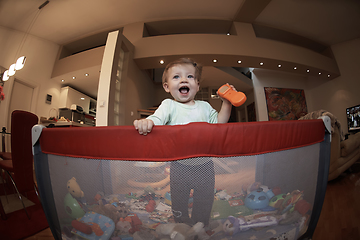 Image showing cute little baby playing in mobile bed