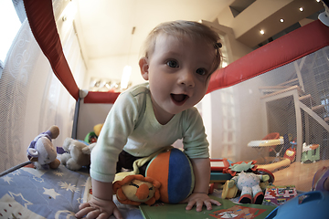 Image showing cute little baby playing in mobile bed