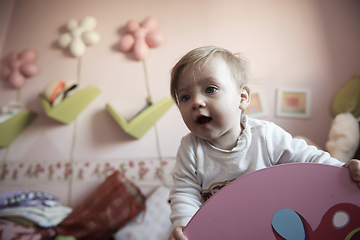 Image showing cute little one year old baby and making first steps