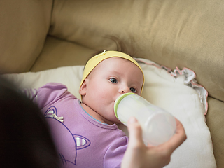 Image showing baby eating milk from bottle