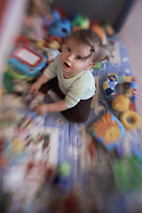 Image showing cute little baby playing in mobile bed