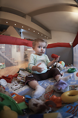 Image showing cute little baby playing in mobile bed