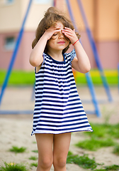 Image showing Cute little girl is playing in playground